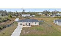 Aerial view of a single-story house with a fenced yard and trampoline at 313 Bolender St, Punta Gorda, FL 33982