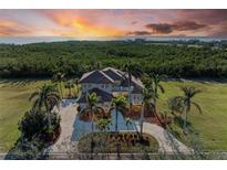 Luxury waterfront home with expansive green space and sunset views at 21391 Harborside Blvd, Port Charlotte, FL 33952