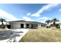 Ranch style home with a two-car garage and landscaped yard at 2219 Bengal Ct, Punta Gorda, FL 33983