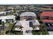 Aerial view of waterfront condo community with boat slips and lush landscaping at 3216 Purple Martin Dr # 123, Punta Gorda, FL 33950