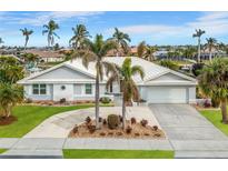 House exterior with palm trees and a landscaped yard at 760 Bal Harbor Blvd, Punta Gorda, FL 33950