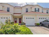 Two-story townhome with red door and attached garage at 1259 Jonah Dr, North Port, FL 34289