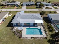 Aerial view showing home, pool, and surrounding neighborhood at 143 Rotonda Cir, Rotonda West, FL 33947