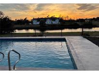 Inviting swimming pool with a sunset view at 143 Rotonda Cir, Rotonda West, FL 33947