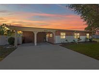 Brick ranch house with carport and landscaped lawn at 2544 Warne St, Port Charlotte, FL 33952