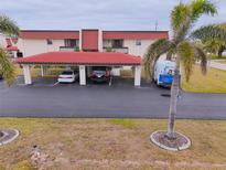 Condo building with carport parking and tropical landscaping at 311 Garvin St # 411B, Punta Gorda, FL 33950