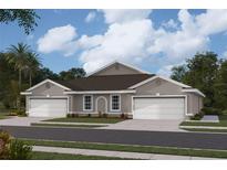 Two-story home with a two-car garage and landscaping at 9368 Sunbeam Cir, Punta Gorda, FL 33950