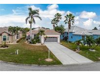 Single-story home with a two-car garage and landscaped yard at 10214 Windsong Rd, Punta Gorda, FL 33955