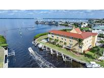 Aerial view of a waterfront property with a boat and dock at 115 Breakers Ct # 111, Punta Gorda, FL 33950