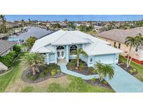 Stunning waterfront home with canal access, lush landscaping, and a large backyard at 1320 Appian Dr, Punta Gorda, FL 33950