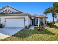 Attractive single-story home with a two-car garage and well-manicured lawn at 1373 San Cristobal Ave, Punta Gorda, FL 33983