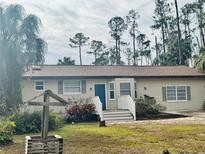 Single-story home with a well-maintained lawn and landscaping at 17455 Masten Ave, Port Charlotte, FL 33954