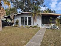 Cute bungalow-style home with a well-maintained lawn and walkway at 2488 Warne St, Port Charlotte, FL 33952