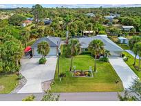 Aerial view of a single-Gathering home with a large yard and detached garage at 472 Eppinger Dr, Port Charlotte, FL 33953