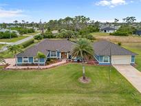 Single-story home with a large backyard and pool, located in a quiet residential neighborhood at 124 Beau Rivage Dr, Rotonda West, FL 33947