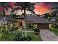 Attractive single-story home with a landscaped yard and two-car garage at 2064 El Cerito Ct, Punta Gorda, FL 33950