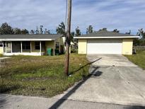 Ranch-style home with attached garage and screened porch at 2430 Dixie Ave, Punta Gorda, FL 33950