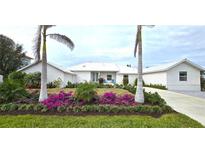 White house with landscaping and palm trees at 311 Bayridge Pl, Punta Gorda, FL 33950