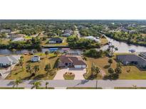 Aerial view of waterfront home with large lot and boat dock at 4122 Library St, Port Charlotte, FL 33948