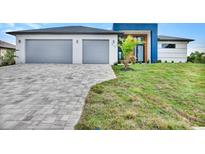 Modern two-story home with gray paver driveway and two-car garage at 15133 Amsterdam, Port Charlotte, FL 33981