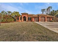 Attractive single-story home with three-car garage and lush landscaping at 3000 Narcissus Ter, North Port, FL 34286