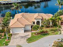 Aerial view of waterfront home with private dock and lush landscaping at 3513 Terin Ct, Punta Gorda, FL 33950