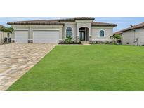 Two-story home with tile roof, three-car garage, and spacious lawn at 4218 Vasco St, Punta Gorda, FL 33950