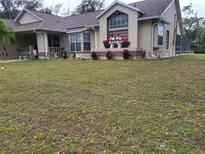 One-story home with spacious front yard and landscaping at 14057 Maxwell Ave, Port Charlotte, FL 33953