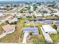 Aerial view of canal-front home with spacious yard and boat dock at 148 Salem Nw Ave, Port Charlotte, FL 33952