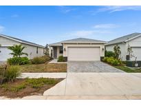 House exterior with attached garage and neatly landscaped front yard at 44259 Saddlewood Ct, Punta Gorda, FL 33982