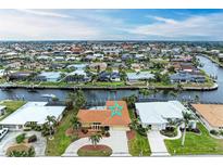 Aerial view of waterfront home with pool and canal access at 820 Via Tunis, Punta Gorda, FL 33950