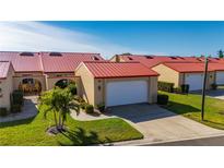 Tan house with red roof and attached garage at 1780 Deborah Dr # 15, Punta Gorda, FL 33950