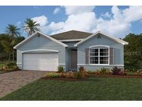 One-story home with light blue exterior, two-car garage, and landscaping at 21043 Hillsborough Blvd, Port Charlotte, FL 33954