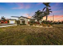 Charming house with a well-manicured lawn and mature trees at 3114 Magdalina Dr, Punta Gorda, FL 33950