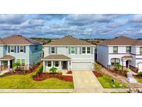 Two-story house with gray siding, landscaping, and a two-car garage at 5274 Grove Mill Loop, Bradenton, FL 34211