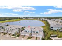 Aerial view of two-story home community near lake at 14150 Poppy Field Loop # 4322, Punta Gorda, FL 33955