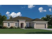 One-story home with a two-car garage and landscaped front yard at 21516 Landis Ave, Port Charlotte, FL 33954