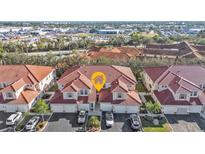 Aerial view of a community of townhouses with red tile roofs and attached garages at 240 W End Dr # 412, Punta Gorda, FL 33950