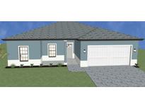 Single-story home with a two-car garage and attractive landscaping at 3733 Basket St, North Port, FL 34288