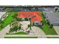 Aerial view of single-Gathering home with canal access and lush landscaping at 820 Bal Harbor Blvd, Punta Gorda, FL 33950