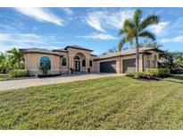 Stunning one-story home with a three-car garage and manicured lawn at 1041 Harbour Park Ct, Punta Gorda, FL 33983