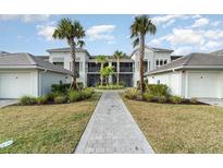 Inviting condominium exterior with lush landscaping and a paver walkway, creating a welcoming entrance at 15950 Grassland Ln # 2622, Punta Gorda, FL 33982