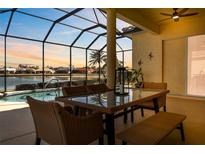 Enjoy dining al fresco overlooking the pool and lake at 1848 Bobcat Trl, North Port, FL 34288