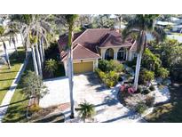 Aerial view of single-story home with tile roof, landscaping, and driveway at 220 Shreve St, Punta Gorda, FL 33950