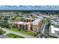 Aerial view of condo building with pool and surrounding area at 3006 Caring Way # 331, Port Charlotte, FL 33952