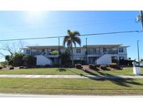 Front view of a two-story building with landscaping, showcasing its appealing facade at 3627 Bal Harbor Blvd # 102, Punta Gorda, FL 33950