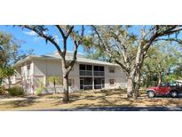 Two-story condo building with screened balconies and mature landscaping at 1051 Forrest Nelson Blvd # A-104, Port Charlotte, FL 33952
