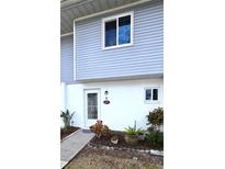 Condo exterior featuring a private entrance and landscaping at 22375 Edgewater Dr # 147, Punta Gorda, FL 33980