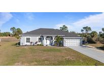 Gray house with a gray roof, white columns, and a two-car garage at 2668 Clovelon St, North Port, FL 34291