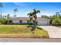 Single-story home with a landscaped lawn and driveway at 1785 Nagorsky Ave, North Port, FL 34288